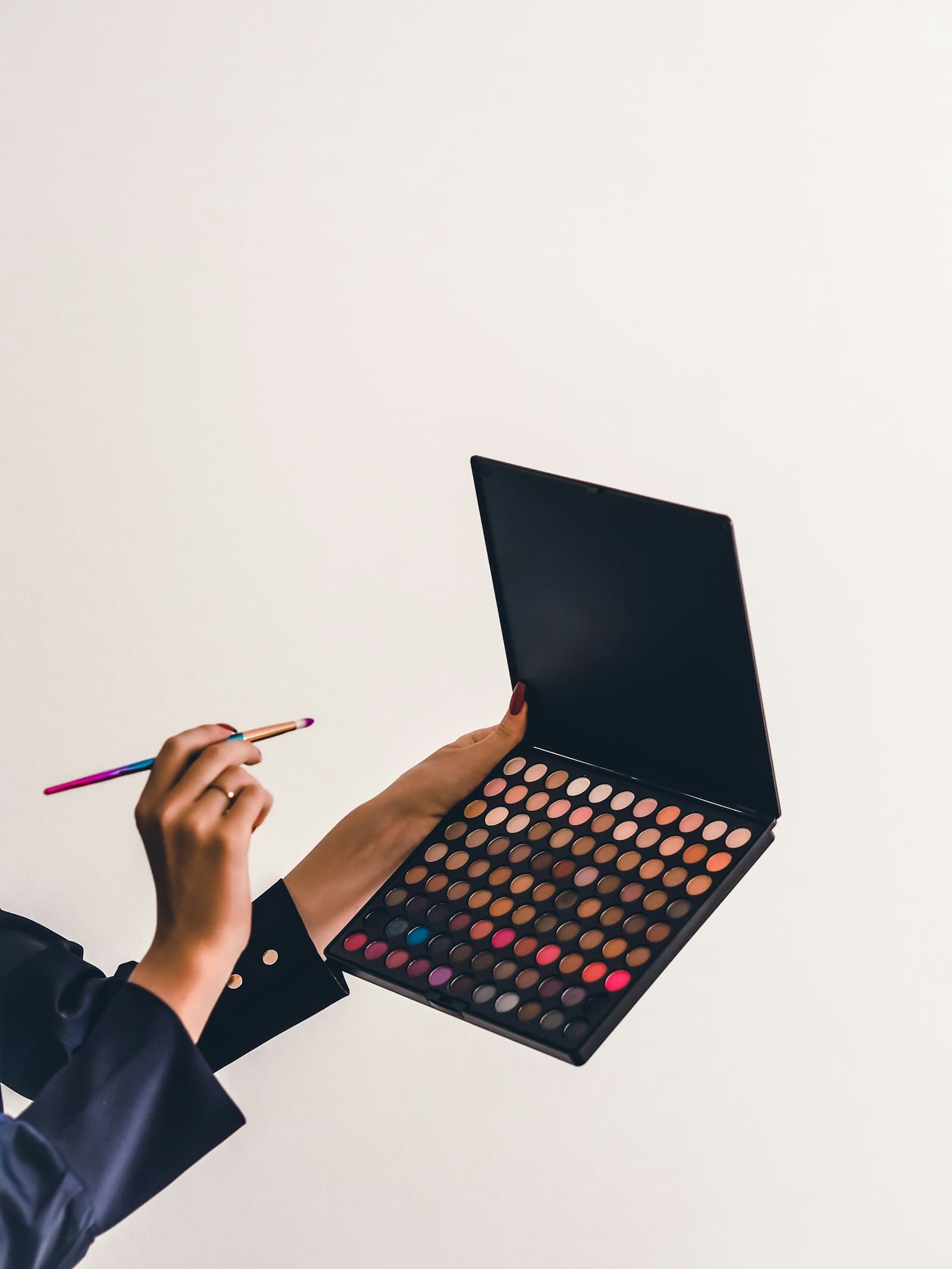 Makeup artist applying makeup to a client in a studio