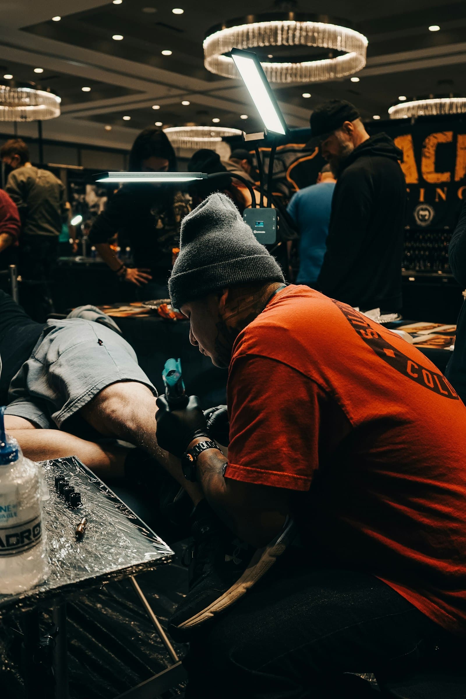 Tattoo artist working on a client in a modern studio