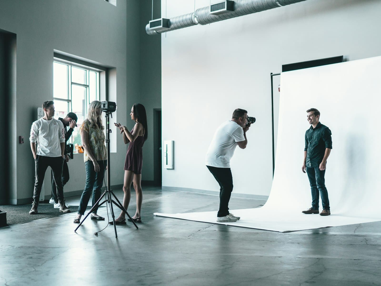 Creative production team collaborating on a photo shoot in a studio
