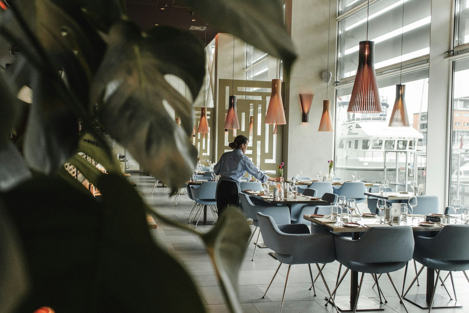 Friendly hospitality worker in a warm professional setting